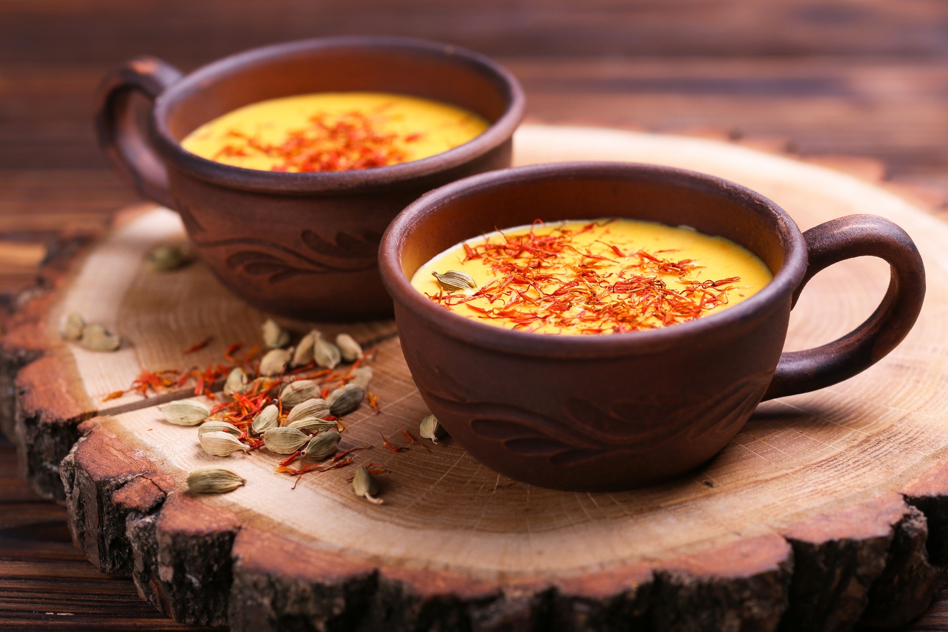 Indian turmeric milk with saffron, cardamom and turmeric. Copyspace